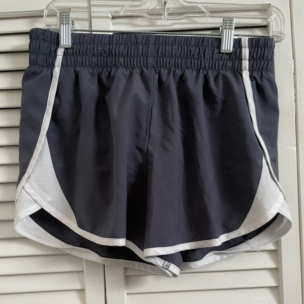 The grey and white athletic shorts are a size XL.